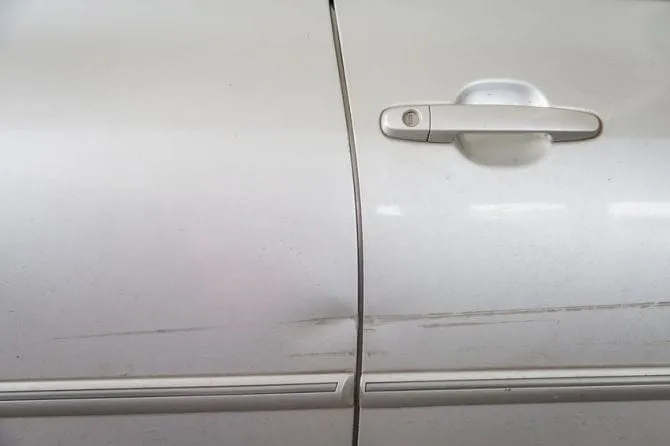 Ding in the door of a silver car