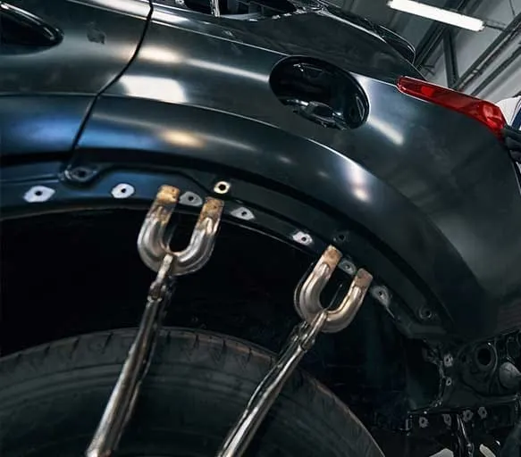 Frame pulling clamps attached to a dark car