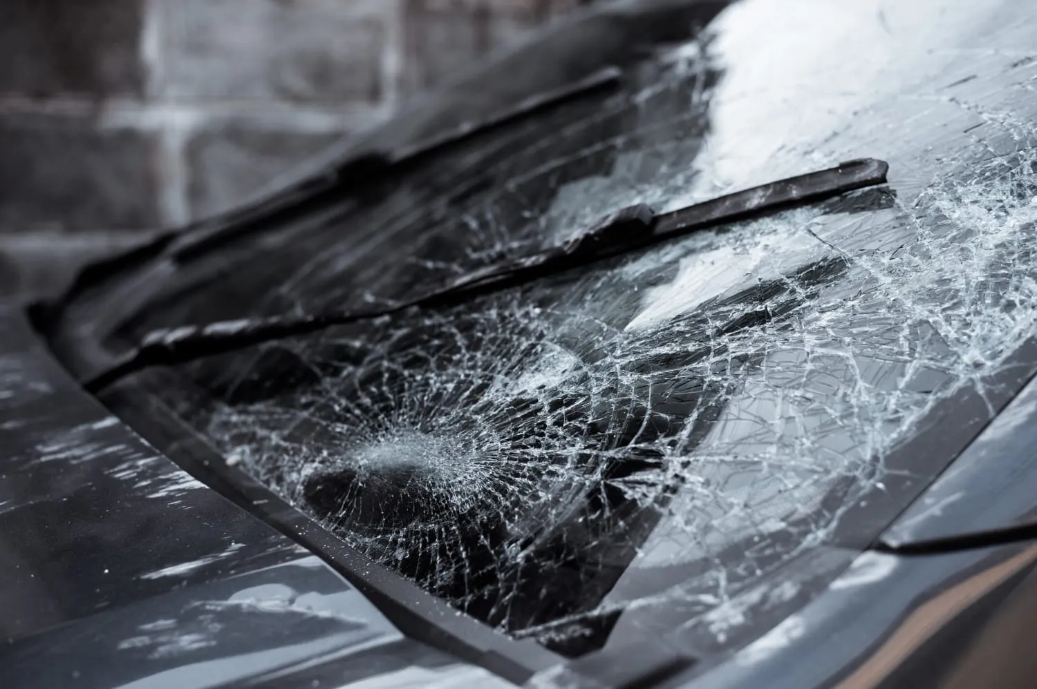 Cracked windshield with a wiper